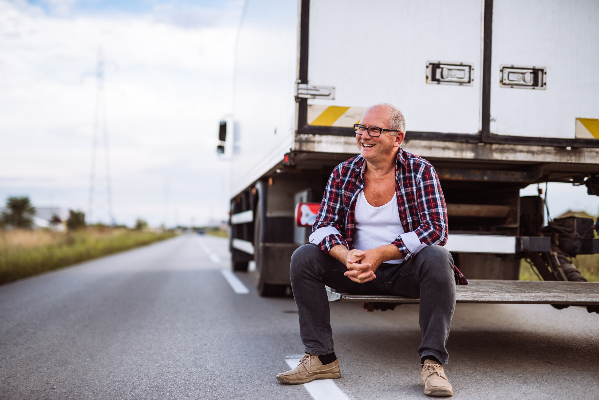 Senior Truck Driver Posing Next To His Truck.